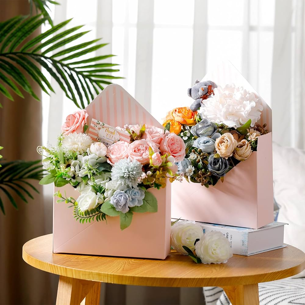 Custom floral box in pink board holding a flower arrangement, styled on a wooden table.