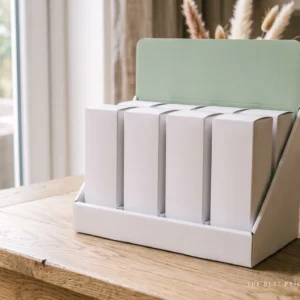 Custom health counter display box in white with a soft sage header panel folded up at the back, holding five white cartons upright in a row.