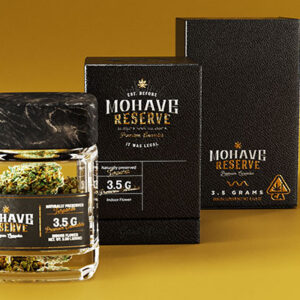 Custom medical marijuana packaging in black with gold print, shown with matching stand up pouches.