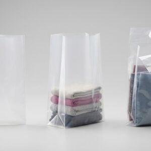 Three custom poly bags compared side by side: a flat open top bag, a gusseted bag standing upright with folded clothing inside, and a zip seal bag with a peel back adhesive flap holding folded fabric
