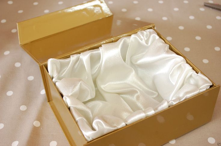 Custom satin lined box in kraft, opened to show a padded ivory satin lining across the tray.