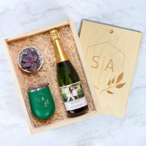Custom wine gift box in kraft with a fitted insert, holding a bottle and gift items with a printed card.