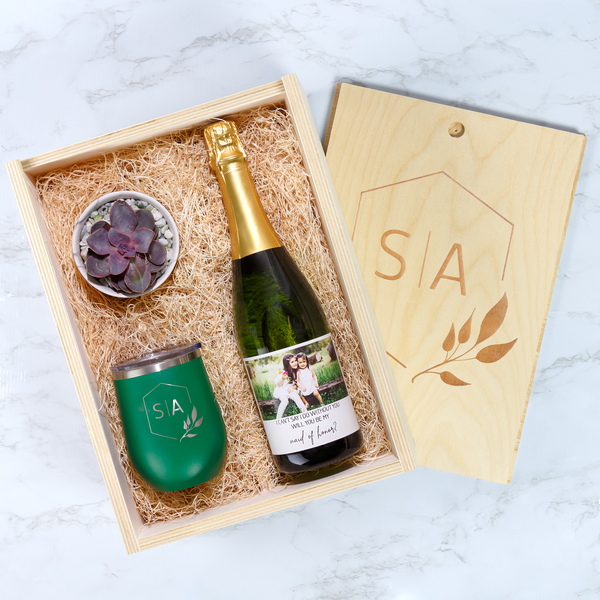 Custom wine gift box in kraft with a fitted insert, holding a bottle and gift items with a printed card.